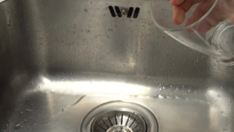 Pouring  drinking water from a kitchen tap into a glass. Video stock 108318992
