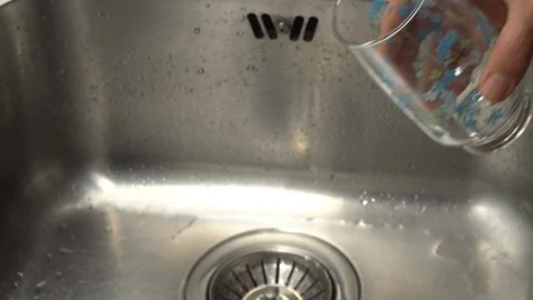 Pouring  drinking water from a kitchen tap into a glass. Video stock 108319100