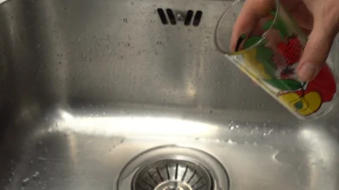 Pouring  drinking water from a kitchen tap into a glass. Video stock 108319126