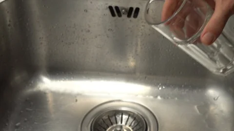 Pouring  drinking water from a kitchen tap into a glass. Video stock 108319127