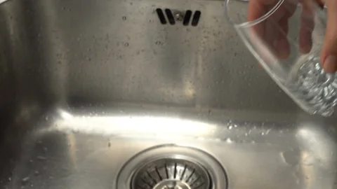 Pouring  drinking water from a kitchen tap into a glass. Video stock 108319146