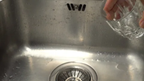 Pouring  drinking water from a kitchen tap into a glass. Video stock 108319163