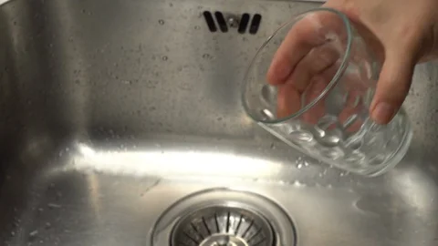 Pouring  drinking water from a kitchen tap into a glass. Video stock 108319174