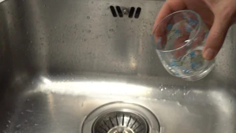 Pouring  drinking water from a kitchen tap into a glass. Video stock 108319345