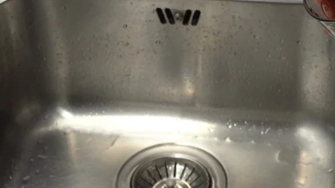 Pouring  drinking water from a kitchen tap into a glass. Video stock 108319362