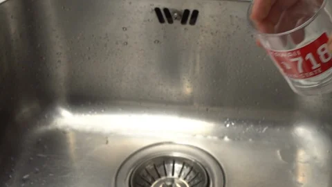 Pouring  drinking water from a kitchen tap into a glass. Video stock 108319470