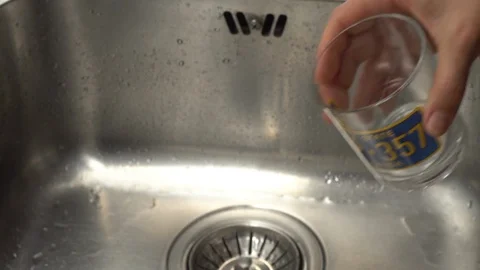 Pouring  drinking water from a kitchen tap into a glass. Video stock 108319479