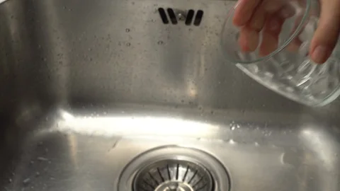 Pouring  drinking water from a kitchen tap into a glass. Video stock 108319540