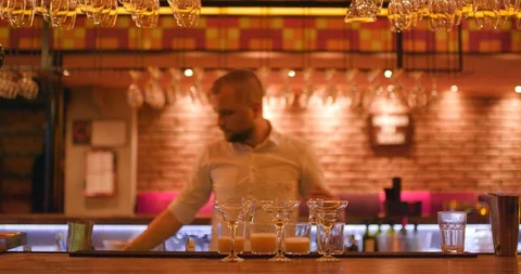 Pouring drinks from shaker simultaneously Stock Footage 106178795