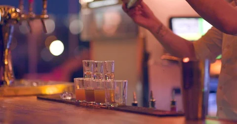 Pouring drinks in shots from shaker Stock Footage 106175722