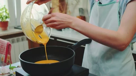 Pouring the egg mass into the pan Video stock 249564338