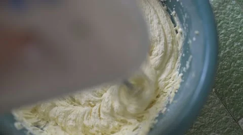 Pouring egg into muffin dough Stock Footage 48853657