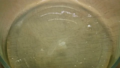 Pouring the egg whites and whole eggs into a glass bowl Stock Footage 166327174