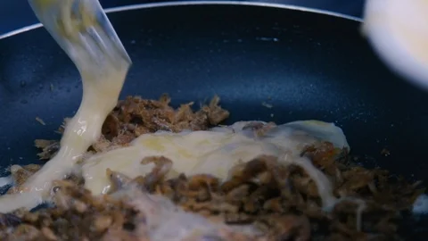 Pouring eggs in a pan Stock Footage 87746612