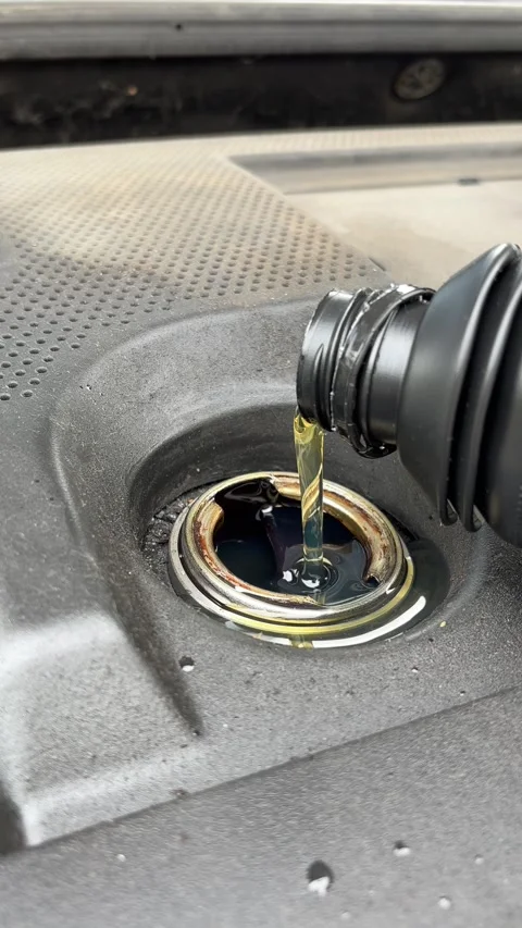 Pouring engine oil into a car engine. Stock Footage 346180695