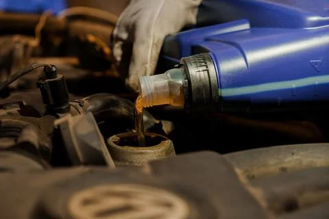 Pouring Engine Oil into a Car Engine for Maintenance Stock Photos