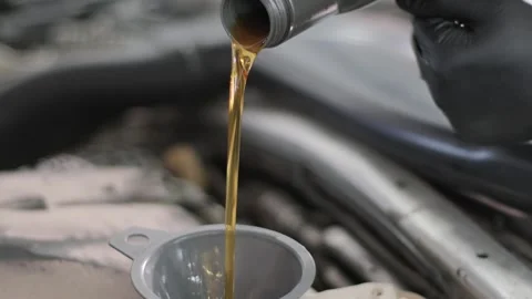 Pouring Engine Oil Into Funnel During Car Maintenance Stock Footage 310700449