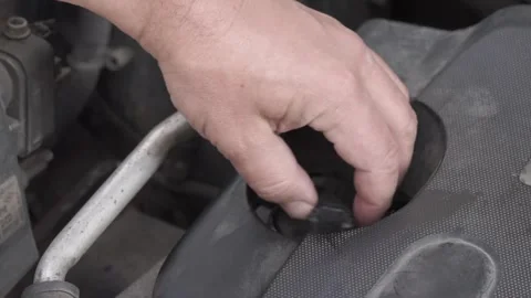 Pouring engine oil into an old car engine  real DIY car maintenance Stock Footage 313194644