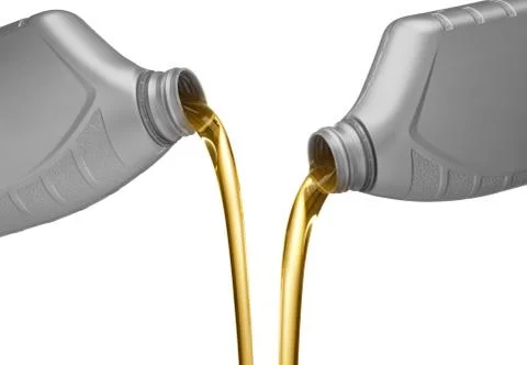Pouring engine oil Stock Photos