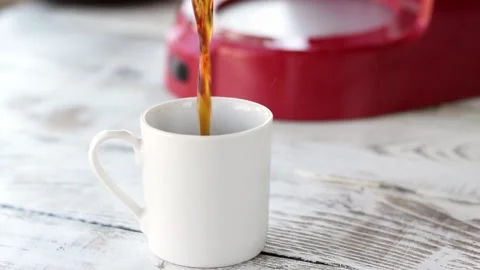 Pouring espresso, brewed in the coffee maker, into the cup Stock Footage 157161677