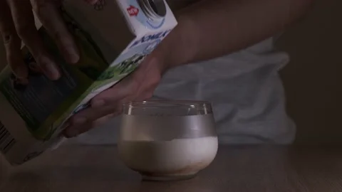 Pouring espresso milk into a cup Stock Footage 215606870