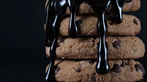 Pouring extra dark melted chocolate topping or sauce over stack of homemade Stock Footage 156069017
