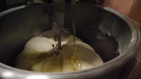 Pouring Extra Virgin Olive Oil on Fresh Italian Pizza Dough in a Professional In Stock Footage 337677787
