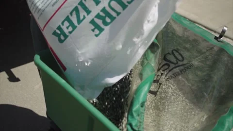 Pouring fertilizer into spreader Video stock 255658481