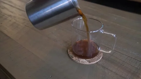 Pouring filter coffee in a glass cup Stock Footage 262452147