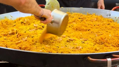 Pouring Fish Broth into Large Seafood Fideua Noodle Paella Stock Footage 341881226