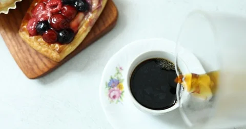 Pouring flannel drip coffee in classy cup on table Stock Footage 117684396
