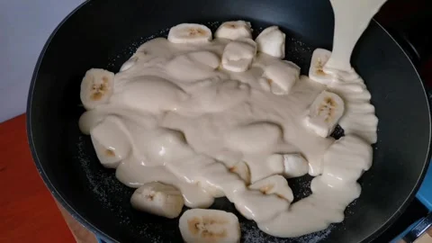 Pouring Flour Mixture Batter on Top of Banana Slices Stock Footage 241511727