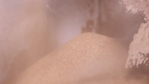 Pouring flour onto pile inside clear plastic container in modern mill closeup Video stock 318926914