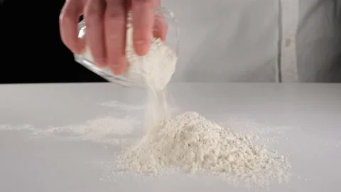 Pouring flour on the white table Stock Footage 219288957