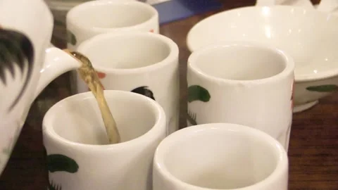 Pouring fragrant tea at a serene tea house Stock Footage 323792367
