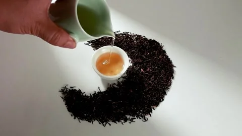 Pouring Fresh Black Tea into Ceramic Cup in Slow Motion Top View Stock Footage 341926397
