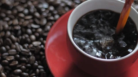 Pouring fresh coffee into red cup Stock Footage 85806038
