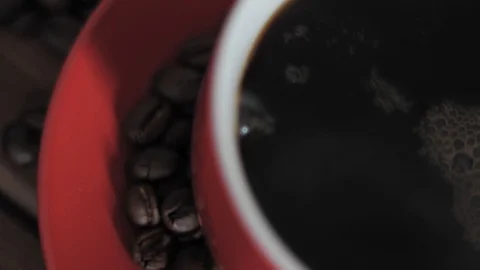 Pouring fresh coffee into red rotating cup 動画素材 85806050