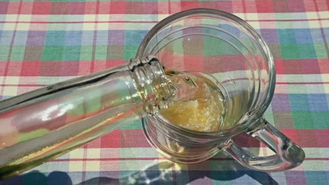Pouring Fresh Cold Beer from Bottle into Glass on Table Stock-Footage 335787935