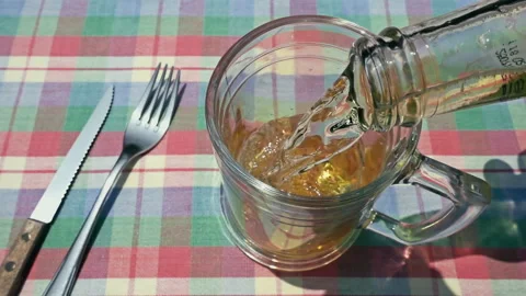 Pouring Fresh Cold Beer from Bottle into Glass on Table Video stock 342970155