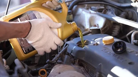 pouring fresh engine oil into the car Stock Video Pond5