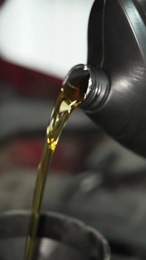 Pouring fresh engine oil from a plastic bottle close up. Stock Footage 341484967