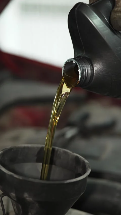 Pouring fresh engine oil from a plastic bottle close up. Stock Footage 341485149