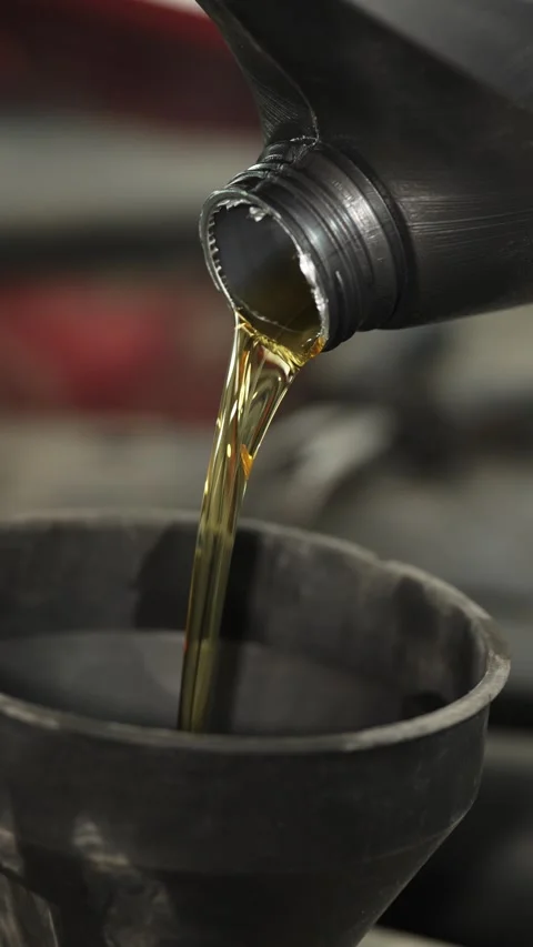 Pouring fresh engine oil from a plastic bottle close up. Stock Footage 341485447