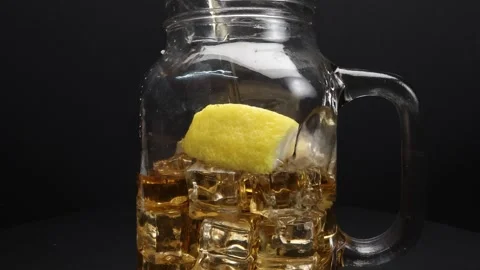 Pouring fresh liquid ice tea drink into transparent glass tea cup and sauce.. Stock-Footage 263186039