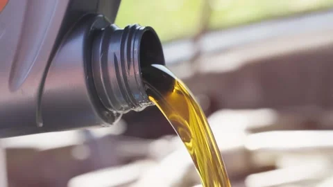 Pouring Fresh Oil to Car Engine, Oil Change to a Auto Stock Footage 132851393