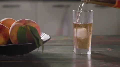 Pouring Fresh Peach Extract Juice Into Glass With Ice Cubes Slow Motion Vídeos de archivo 344034165