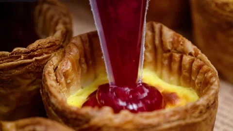 Pouring Fresh Raspberry Jam into a Flaky Custard Pastry Cup Stock Footage 343018379