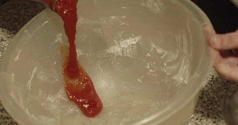 Pouring fresh red tomato juice in a pot - 4K extreme slow motion - top view Stock Footage 152168853