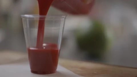 Pouring fruit smoothie into plastic container Stock Footage 194478598
